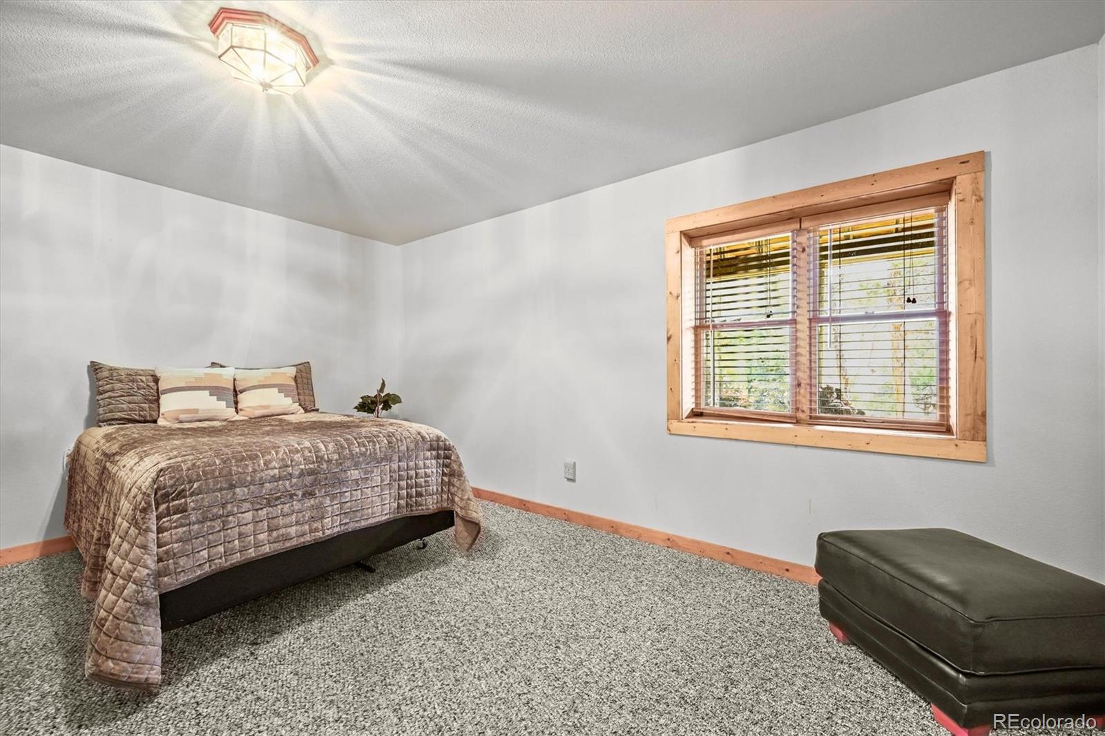 9868 South Overlook Road Sedalia, CO 80135 - Photo 49 of 50 a bedroom with a bed and a dresser