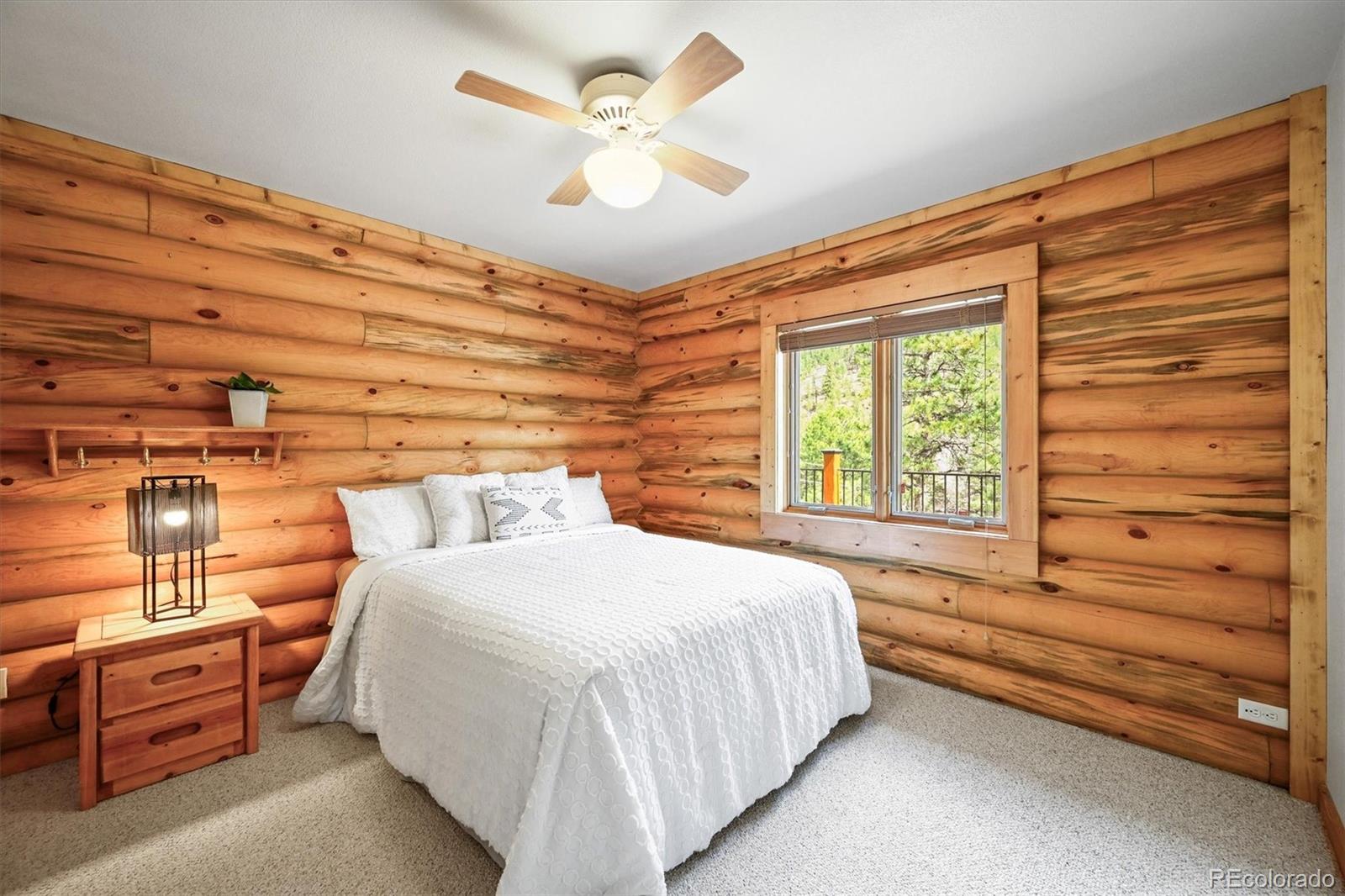 9868 South Overlook Road Sedalia, CO 80135 - Photo 7 of 50 a bedroom with a bed and a chandelier