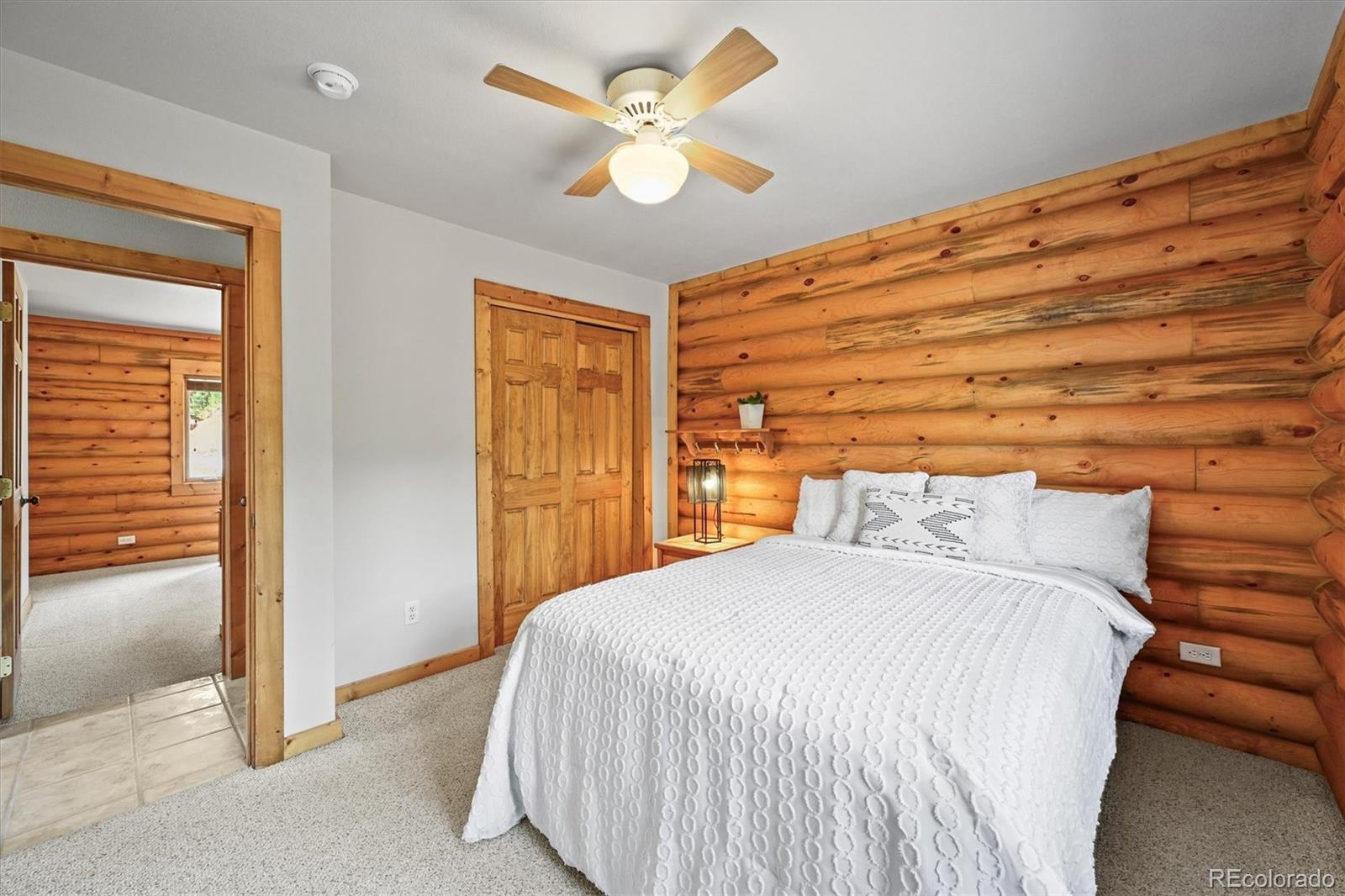 9868 South Overlook Road Sedalia, CO 80135 - Photo 8 of 50 a bedroom with a bed and a chandelier