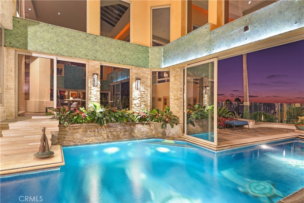 51 Ritz Cove Drive Dana Point, CA 92629 - Photo 46 of 51 a view of a patio with table and chairs and floor to ceiling window