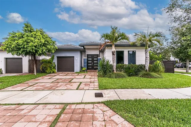 a front view of a house with a garden