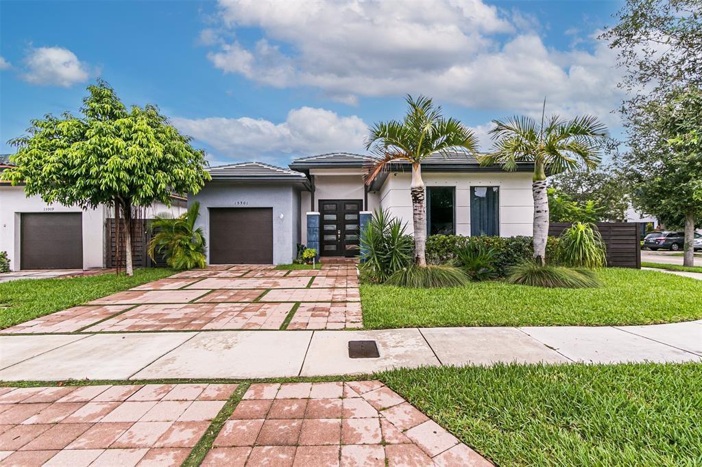15901 Southwest 136 Way Miami, FL 33196 - Photo 1 of 34 a front view of a house with a garden