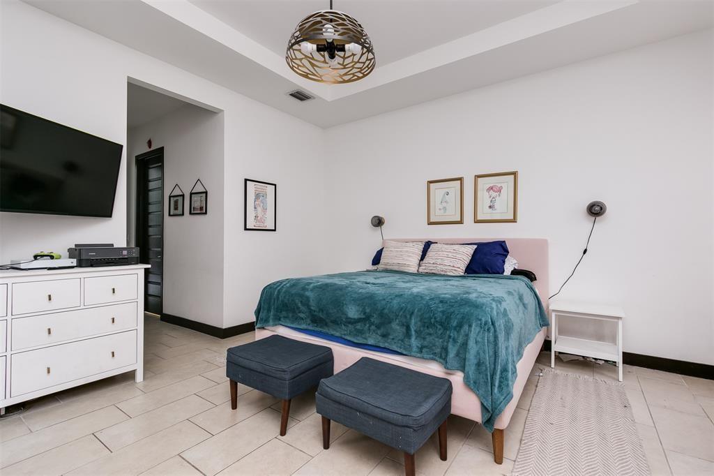 15901 Southwest 136 Way Miami, FL 33196 - Photo 21 of 34 a bedroom with a bed and a flat screen tv