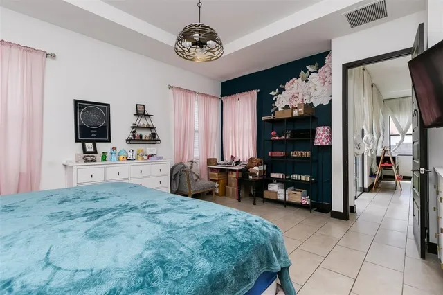 a bedroom with furniture and a flat screen tv