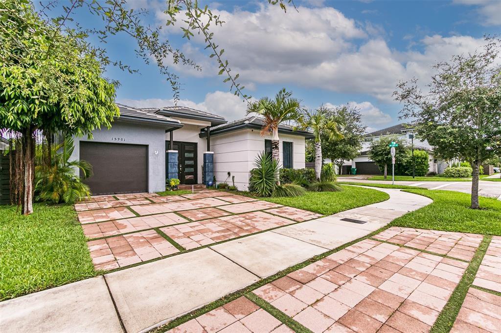 15901 Southwest 136 Way Miami, FL 33196 - Photo 4 of 34 a patio with a yard and plants