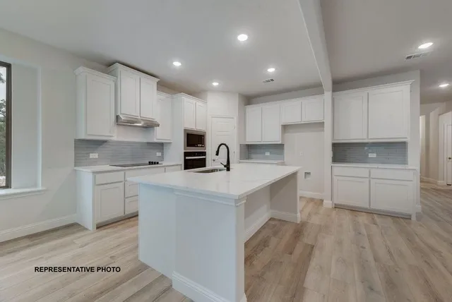a kitchen with white cabinets and white appliances
