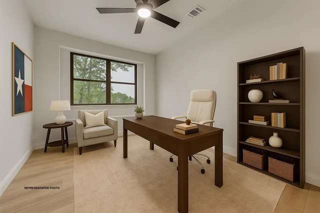 a living room with furniture a window and a flat screen tv