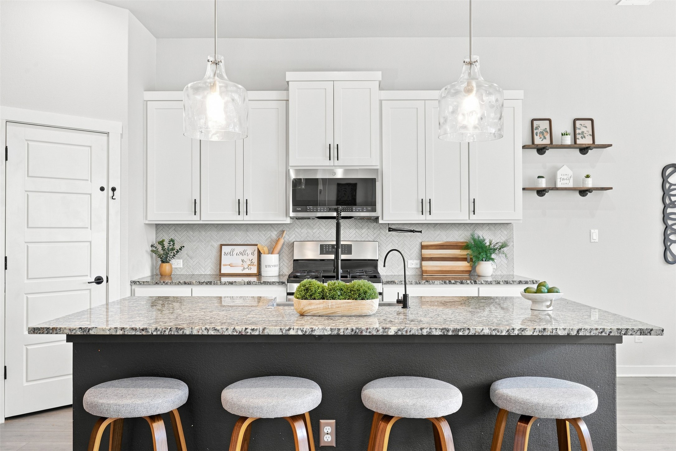 336 Berkeley Place Georgetown, TX 78628 - Photo 13 of 36 Polished stone countertops pair elegantly with clean white cabinetry in this modern cooking space.