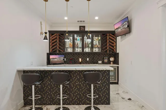 a kitchen with stainless steel appliances kitchen island granite countertop a refrigerator and cabinets