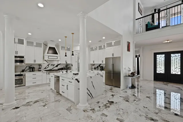 a white house with tree in front of it