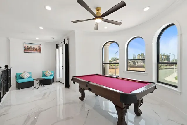 a view of a house with backyard and sitting area