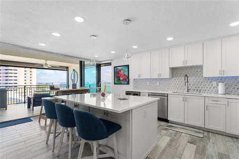 a kitchen with stainless steel appliances a stove a sink a refrigerator and a refrigerator