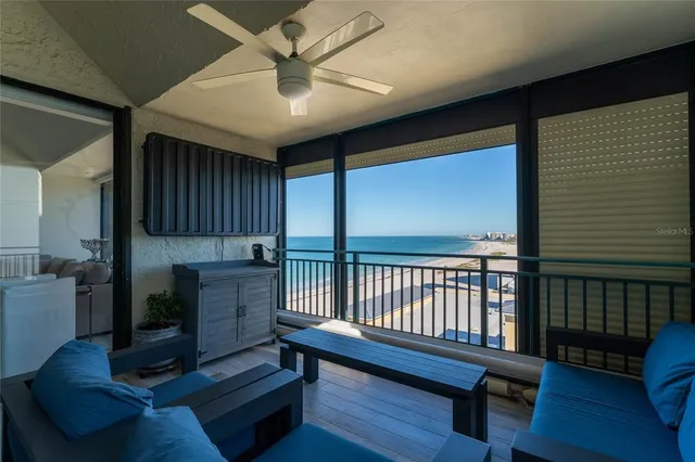 a bedroom with a bed a flat tv screen and dresser