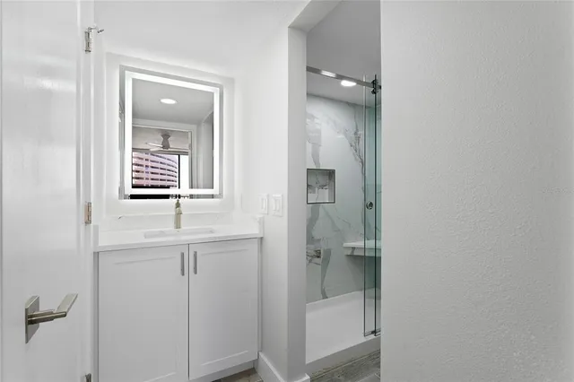 a bathroom with a shower and a sink