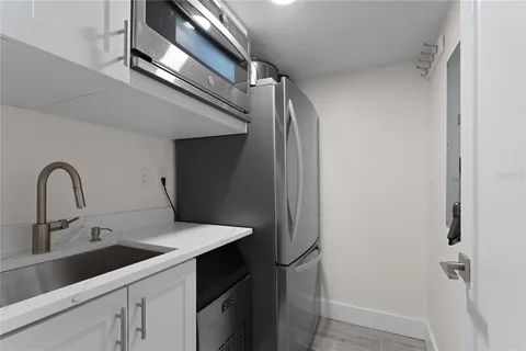 a spacious bathroom with a double vanity sink toilet mirror and shower