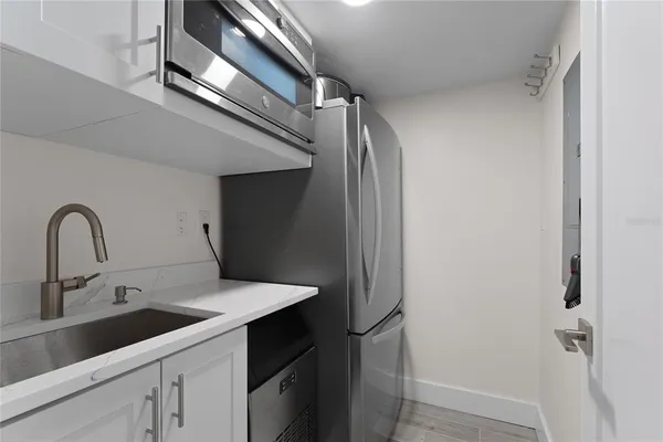 a spacious bathroom with a double vanity sink toilet mirror and shower