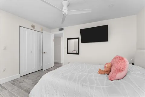 a bedroom with furniture and a wooden floor
