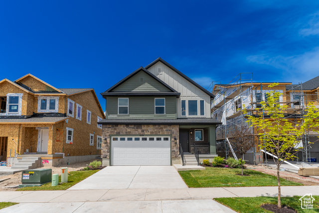 1015 3685 West, Unit 247 Lehi, UT 84048 - Photo 1 of 1 View of front of home with an attached garage, concrete driveway, and stone siding