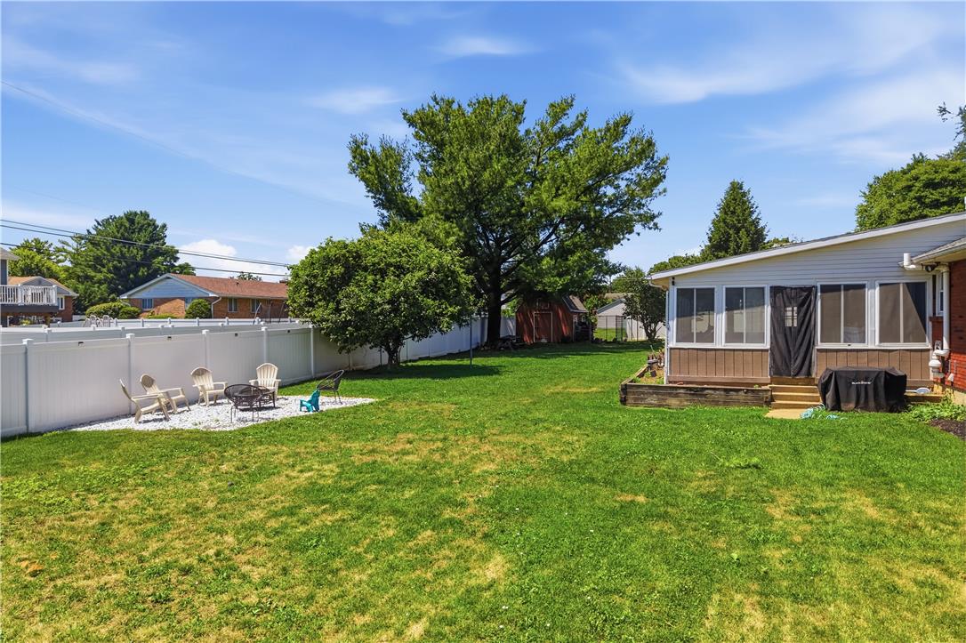 2918 Keystone Street Bethlehem, PA 18020 - Photo 37 of 54 A spacious backyard with mature trees and a fire pit area offers outdoor recreation.