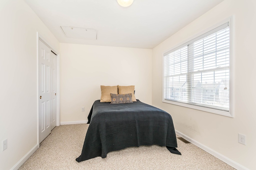 41 Boston Road, Unit 124 Billerica, MA 01862 - Photo 12 of 18 a bedroom with a bed and a window