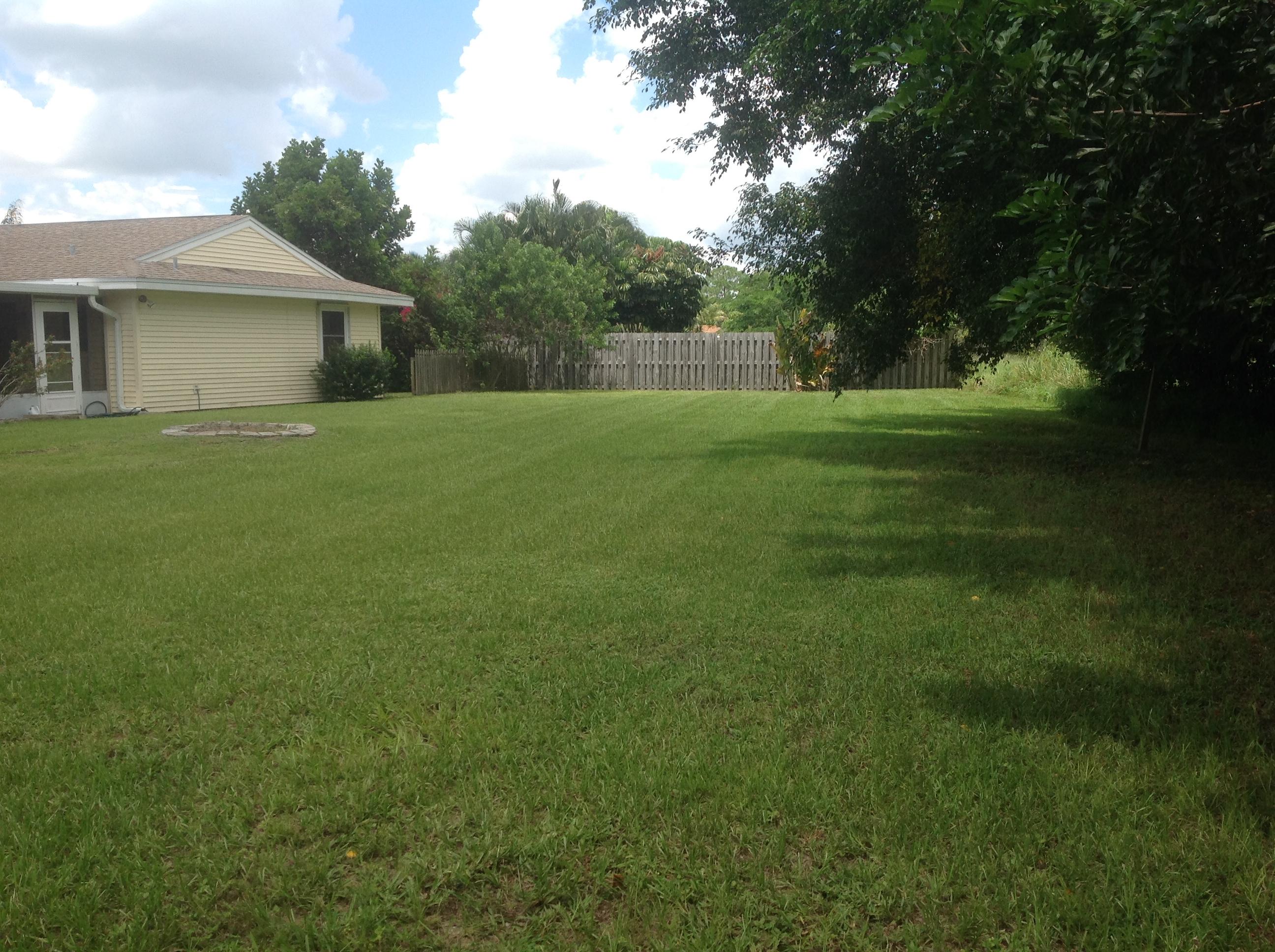 1545 Southeast Pitcher Road Port St. Lucie, FL 34952 - Photo 21 of 22 a front view of house with yard and green space