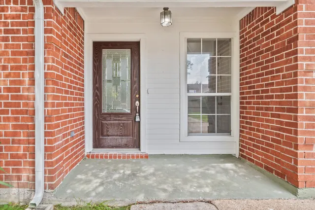 front view of a house with a yard and an trees