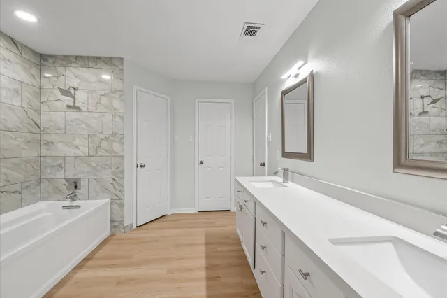 a kitchen with white cabinets appliances and sink