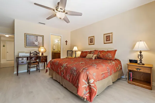 a spacious bedroom with a bed and a chandelier