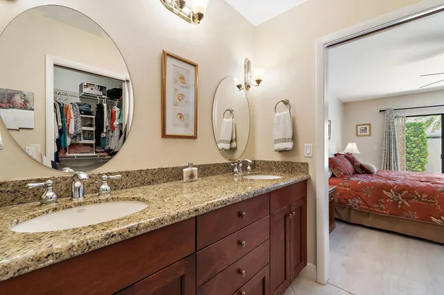 a en suite bathroom with double vanity sinks and a mirror