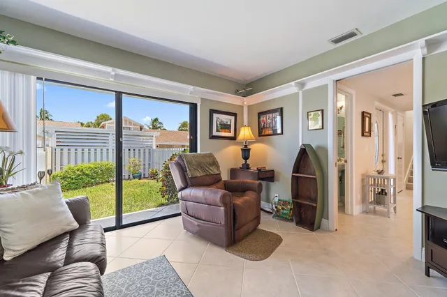a living room with furniture and a floor to ceiling window