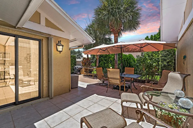 a patio with a patio table and chairs