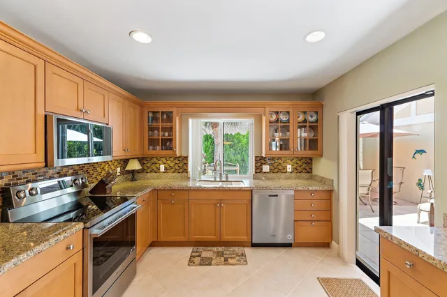 a large room with a large window and furniture