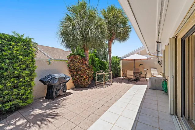 a view of a patio with table and chairs and potted plants