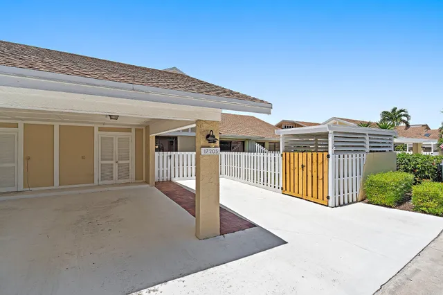 an aerial view of multiple houses with a yard