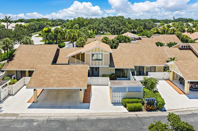 an aerial view of residential houses with outdoor space and ocean view