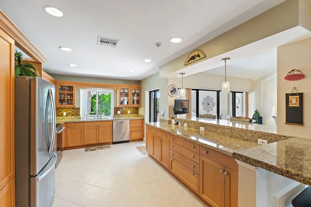 a large white kitchen with a large window