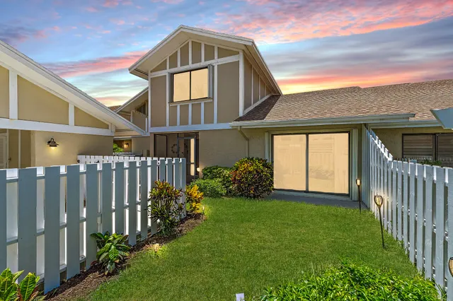 a front view of a house with yard and porch