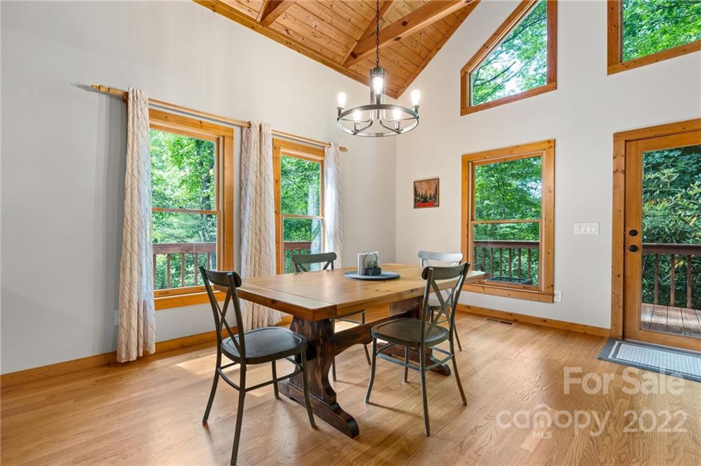 7 Twin Mountain View Road Canton, NC 28716 - Photo 16 of 36 a view of a dining room with furniture a chandelier and wooden floor