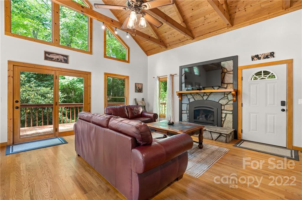 7 Twin Mountain View Road Canton, NC 28716 - Photo 21 of 36 a living room with furniture a flat screen tv and a fireplace
