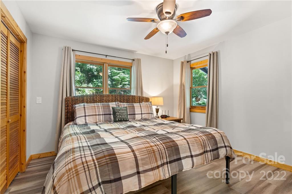 7 Twin Mountain View Road Canton, NC 28716 - Photo 24 of 36 a bedroom with a large bed and a large window