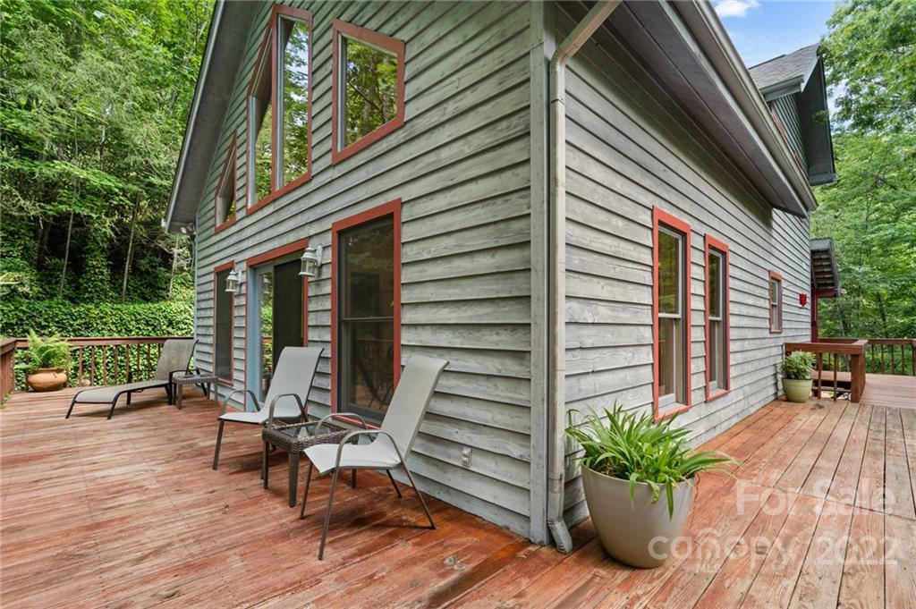 7 Twin Mountain View Road Canton, NC 28716 - Photo 6 of 36 a view of a patio with a table and chairs and potted plants