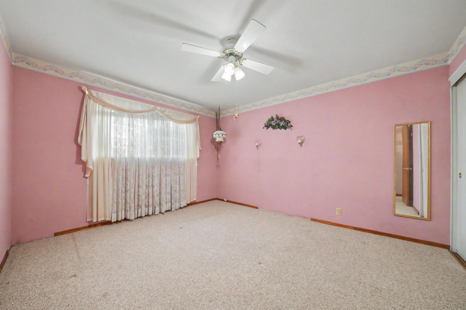 626 Sutter Lane Ione, CA 95640 - Photo 14 of 21 an empty room with windows and fan