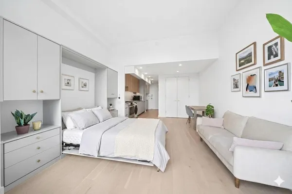 a spacious bedroom with a bed and a couch