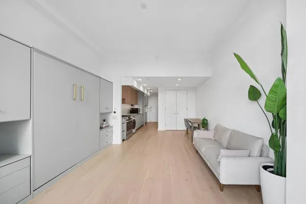 a kitchen with white cabinets and white appliances