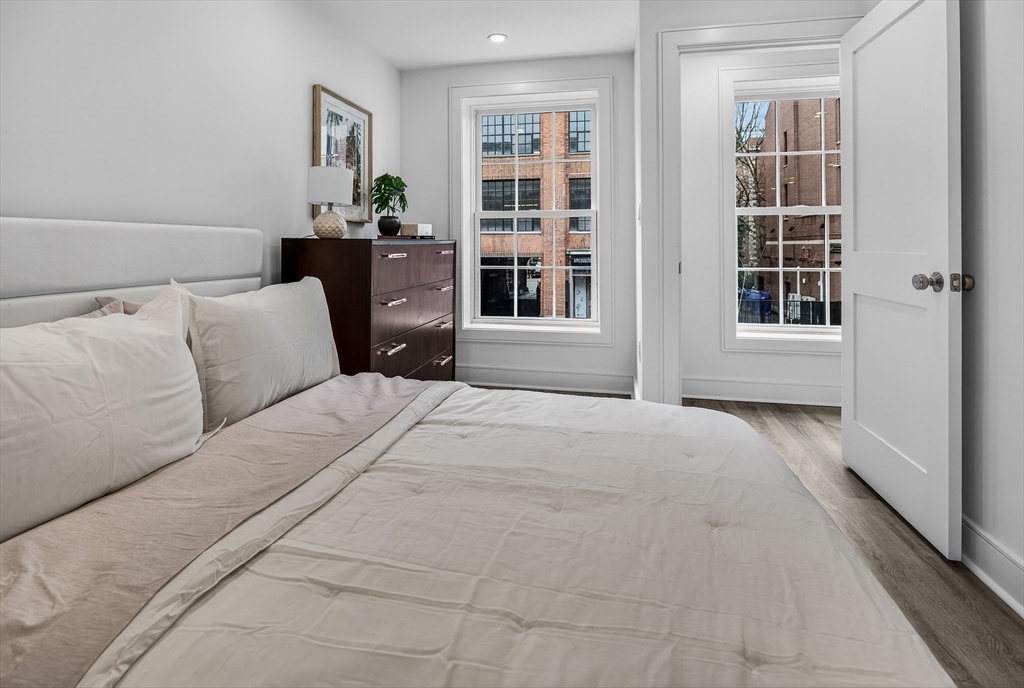 149 Charles Street, Unit 4 Boston, MA 02114 - Photo 11 of 11 a bedroom with a large bed closet and window