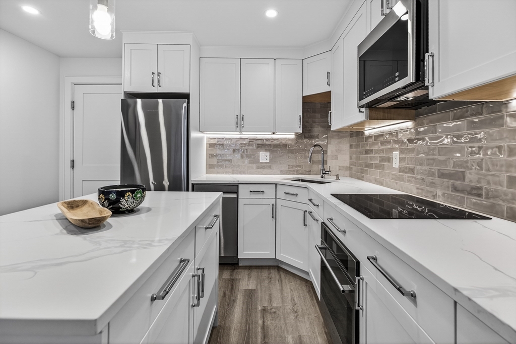 149 Charles Street, Unit 4 Boston, MA 02114 - Photo 5 of 11 a kitchen with a sink stove and refrigerator