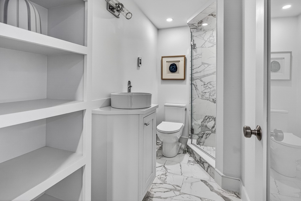 149 Charles Street, Unit 4 Boston, MA 02114 - Photo 9 of 11 a bathroom with a toilet sink and shower