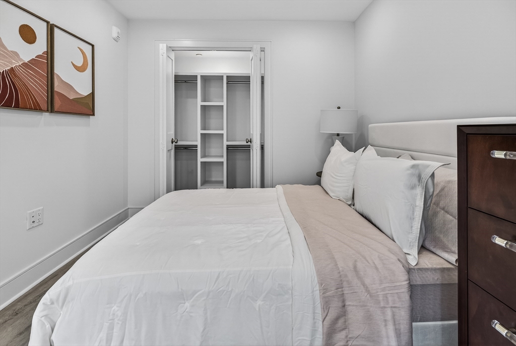 149 Charles Street, Unit 4 Boston, MA 02114 - Photo 10 of 11 a bedroom with a bed and wall painting