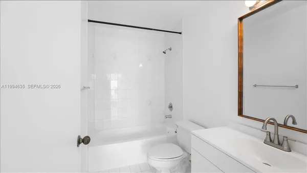 a bathroom with a sink mirror toilet and bathtub