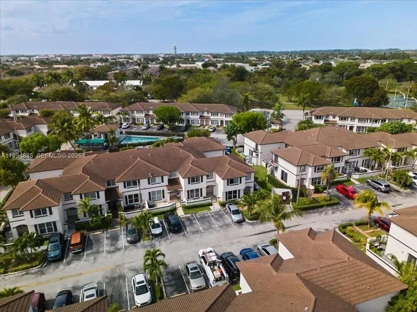 an aerial view of residential houses with outdoor space